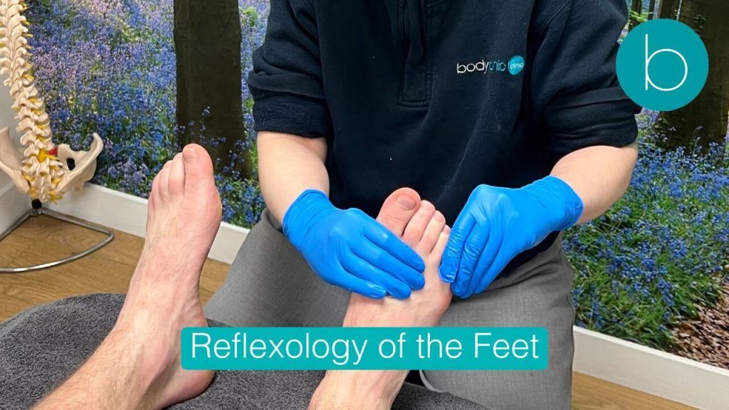 Clinical photo of reflexology being performed on the toes and upper foot for sinus and head tension relief.