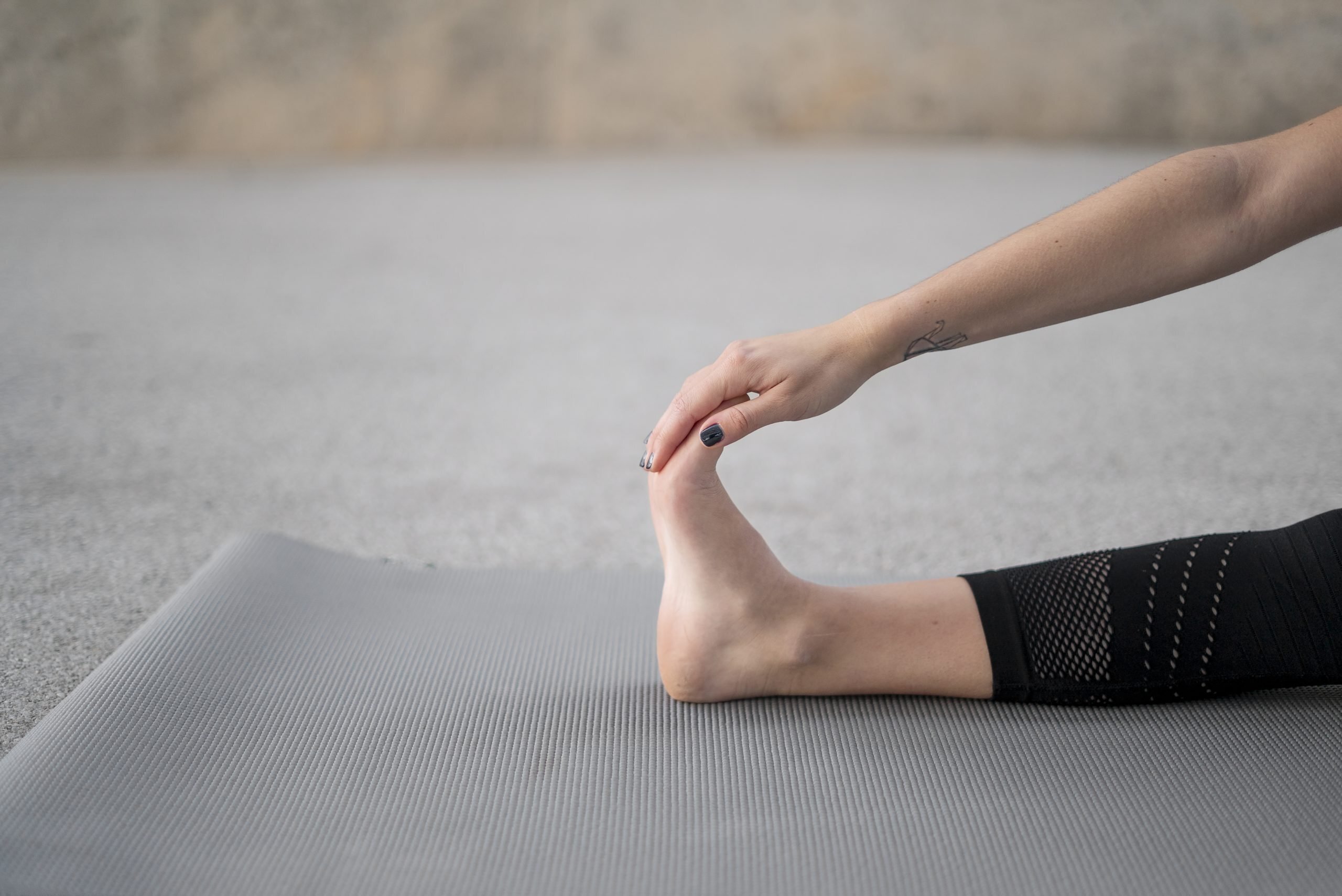close up hand stretching foot scaled How to Treat Ankle Pain without Medication