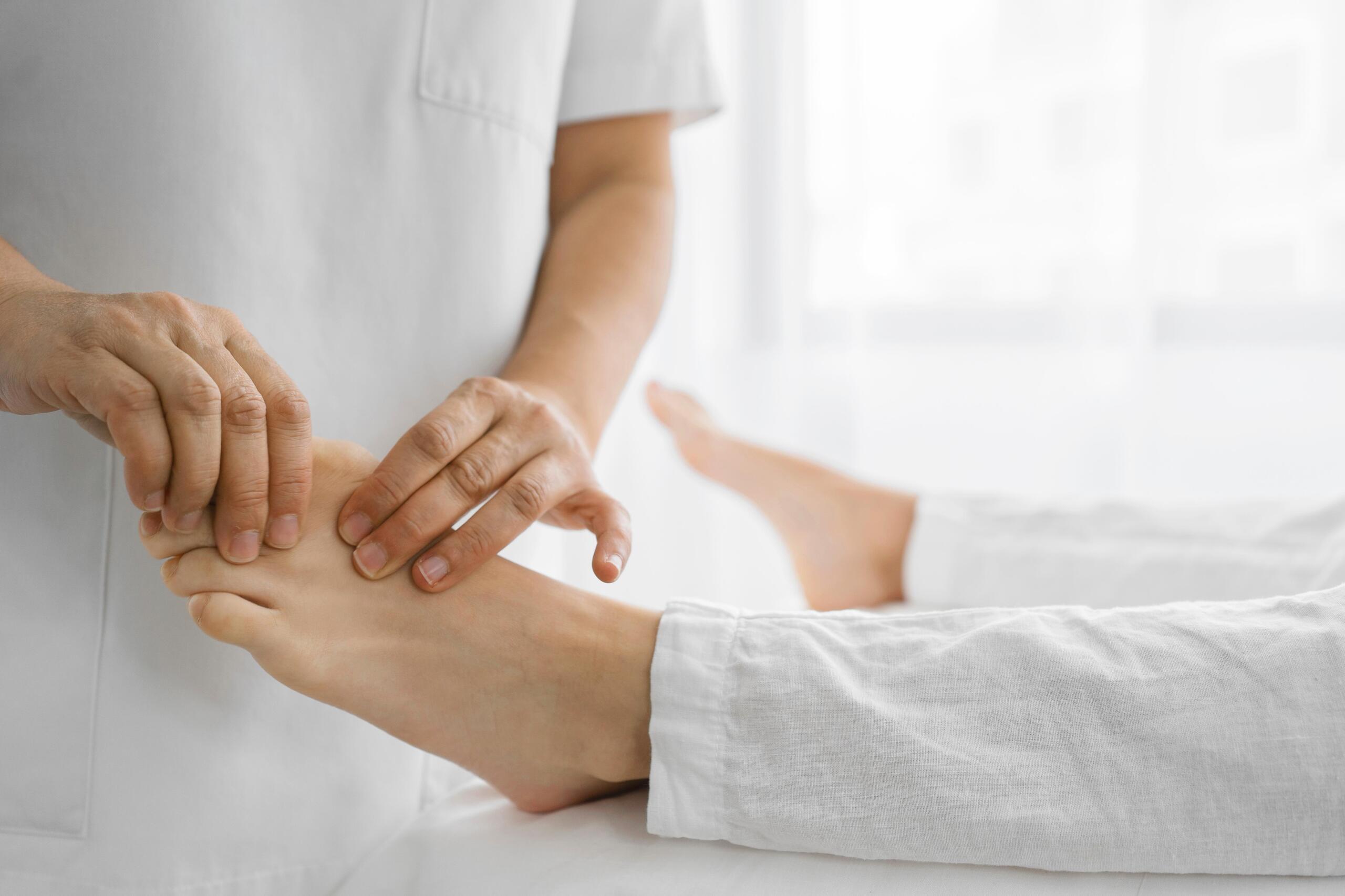 osteopathist treating patient his feet ezgif.com resize What Happens at a Foot Health Appointment?
