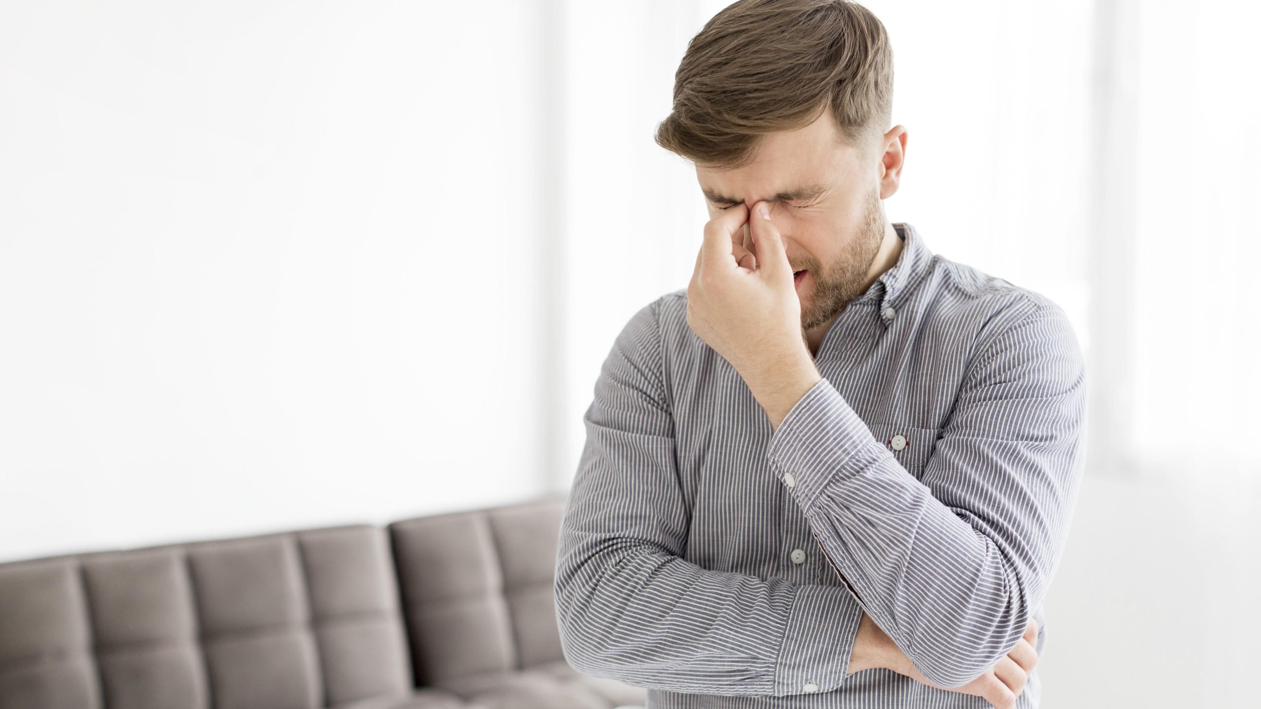 young man with headache scaled Top 10 Benefits of Booking a Chiropractor Appointment