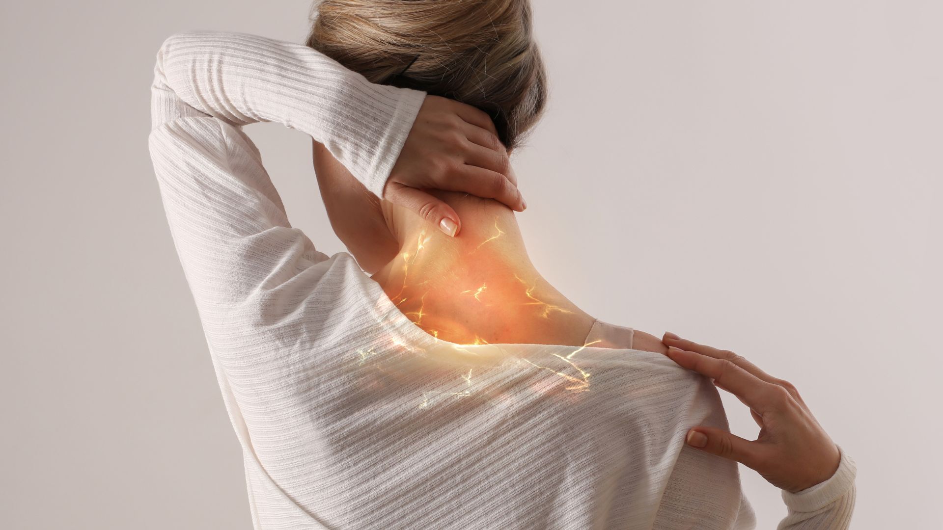 Woman touching her neck and shoulder in discomfort, with digital effects highlighting nerve pain or muscle tension in the upper back area.