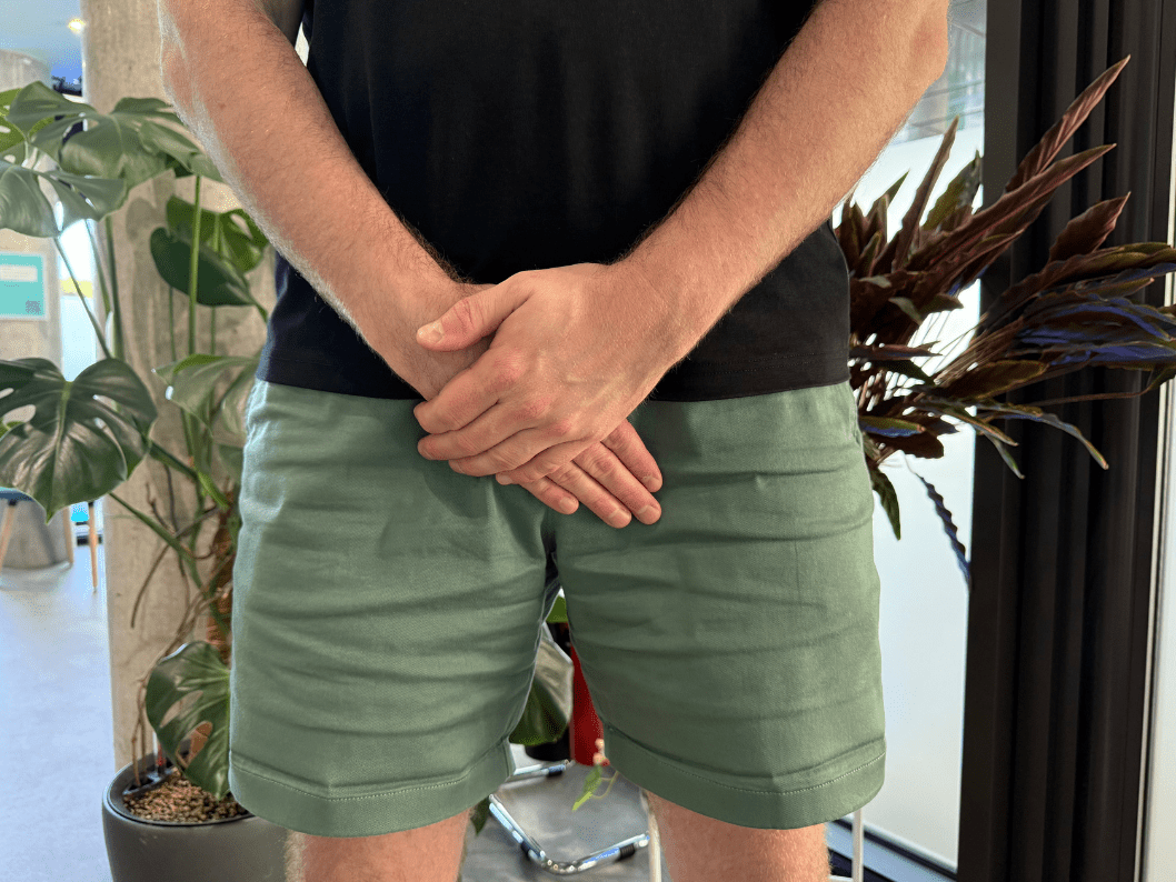 man with hands infront of his groin
